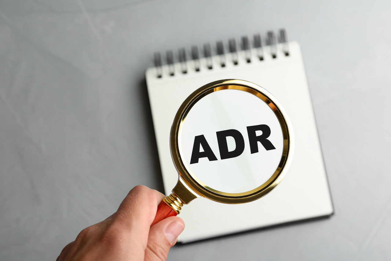 Magnifying glass over ADR, the average daily rate used in hotel revenue management
